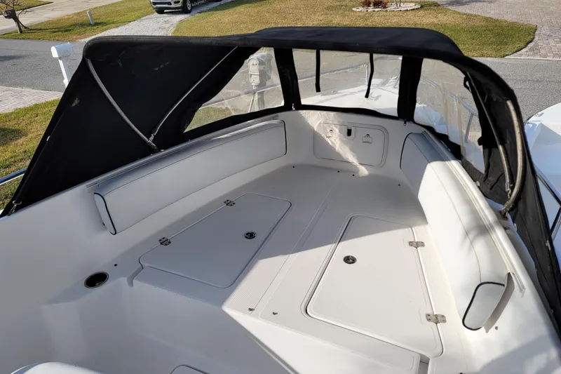 Slide: The Image of 2008 Pro-Line 24 Super Sport boat interior with canopy, featuring spacious seating and storage compartments. - 25