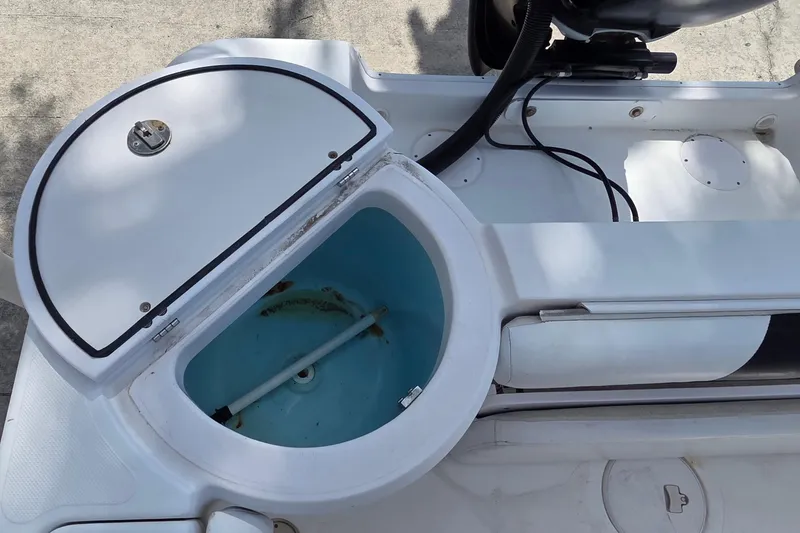 Slide: The Image of Open storage compartment on 2008 Pro-Line 24 Super Sport boat, showing interior details. - 5