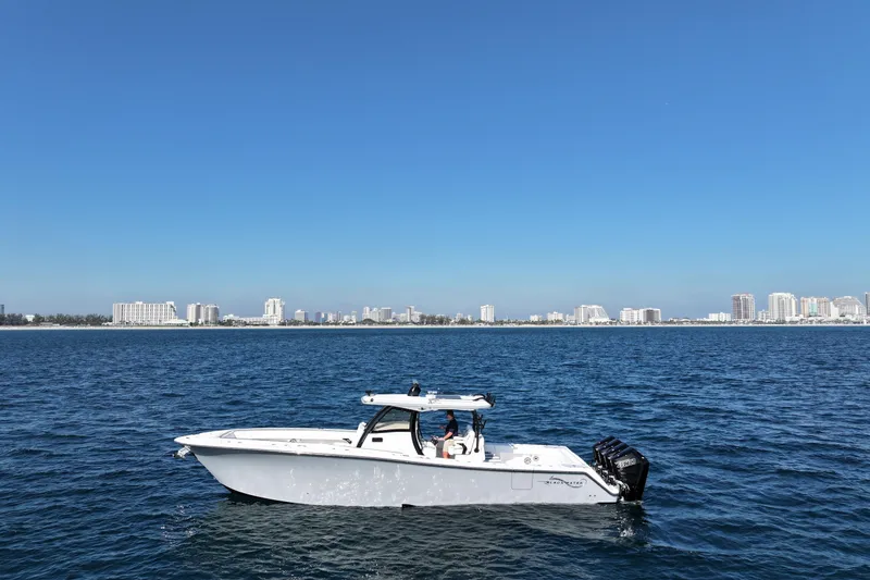 Slide: The Image of 2026 Blackwater 41 Sportfish boat on open water with city skyline in background. - 21