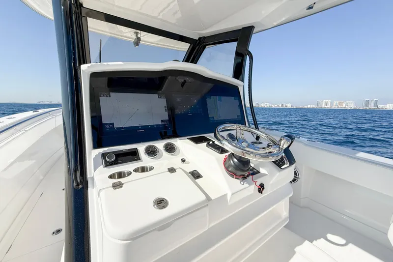 Slide: The Image of 2026 Blackwater 41 Sportfish helm with advanced navigation screens on open water. - 48