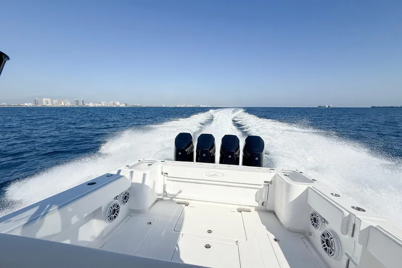 Slide: The Image of 2026 Blackwater 41 Sportfish cruising on open sea with city skyline in background. - 52