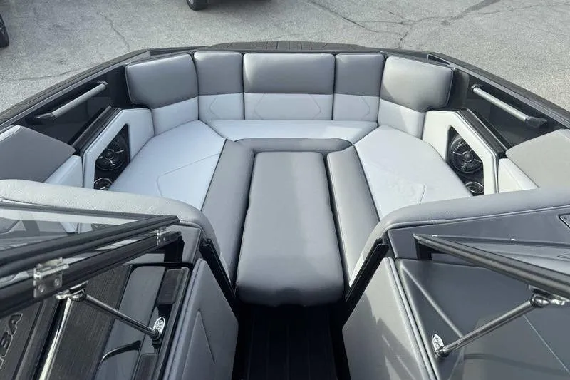 Slide: The Image of 2026 Moomba Tykon boat interior with gray seating and modern design. - 12