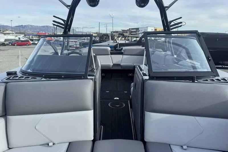 Slide: The Image of 2026 Moomba Tykon boat interior with gray seating and open windshield. - 9