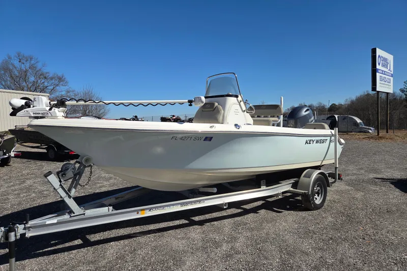 The Image of 2021 Key West 189 FS boat on trailer, parked outdoors under clear blue sky. - 0