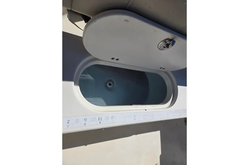 Slide: The Image of 2021 Key West 189 FS boat storage compartment with measuring scale. - 10
