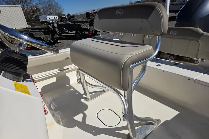 Slide: The Image of 2021 Key West 189 FS boat interior with steering wheel and cushioned seat. - 12