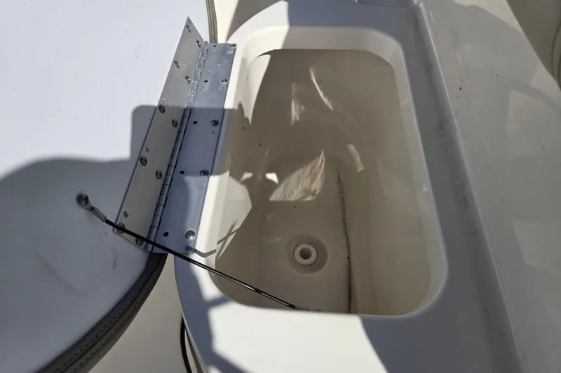 Slide: The Image of 2021 Key West 189 FS boat compartment with open hatch and visible hinge. - 16