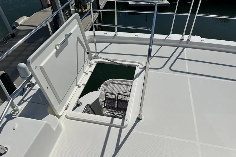 Slide: The Image of 2021 Beneteau Swift Trawler 41 Fly deck hatch open, revealing interior stairs. - 10