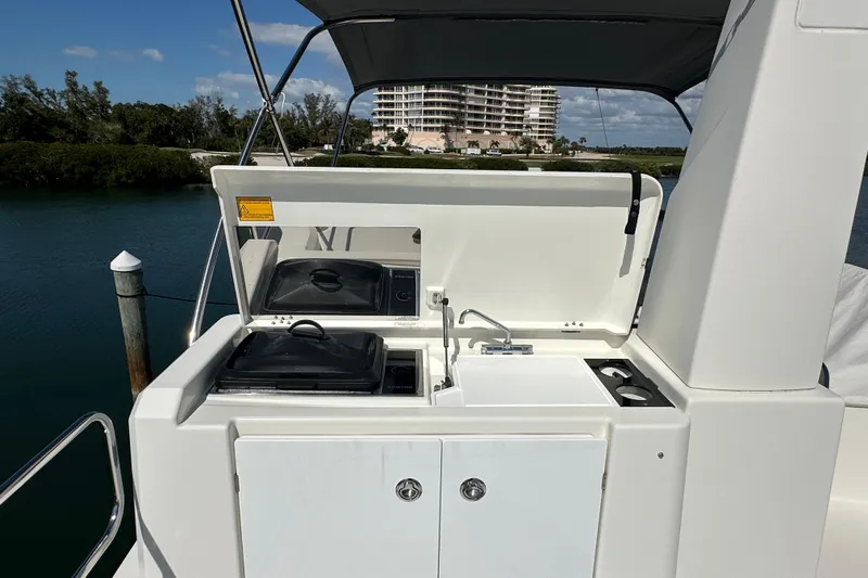 Slide: The Image of Outdoor kitchen on 2021 Beneteau Swift Trawler 41 Fly, featuring grill and sink. - 12