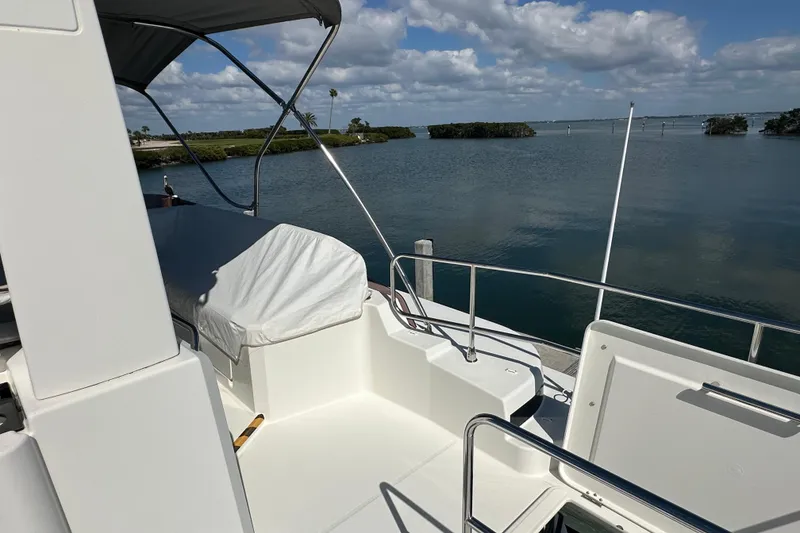 Slide: The Image of Beneteau Swift Trawler 41 Fly 2021 on serene water with clear skies. - 14