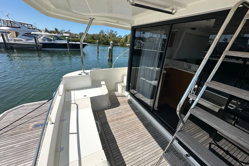 Slide: The Image of 2021 Beneteau Swift Trawler 41 Fly, spacious deck with modern design, docked at marina. - 16