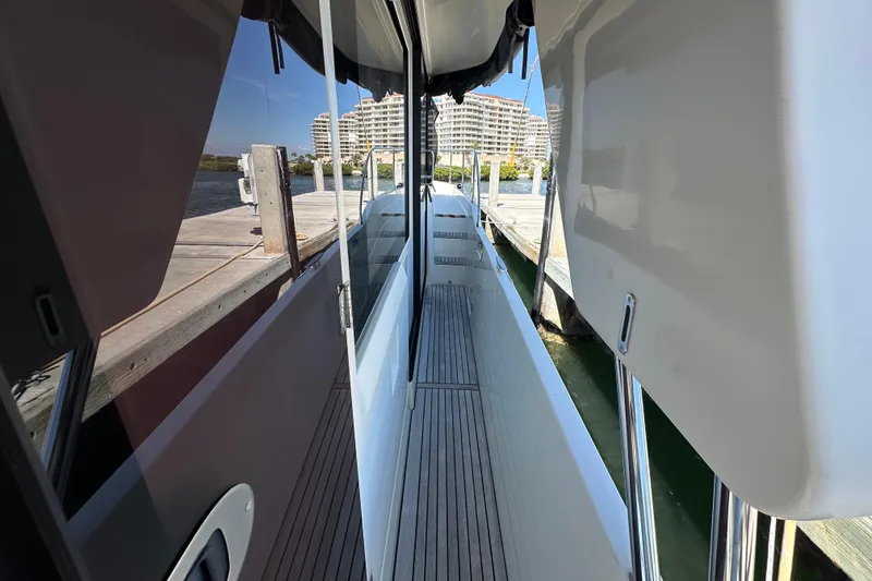 Slide: The Image of 2021 Beneteau Swift Trawler 41 Fly docked, showcasing sleek side deck and modern design. - 17