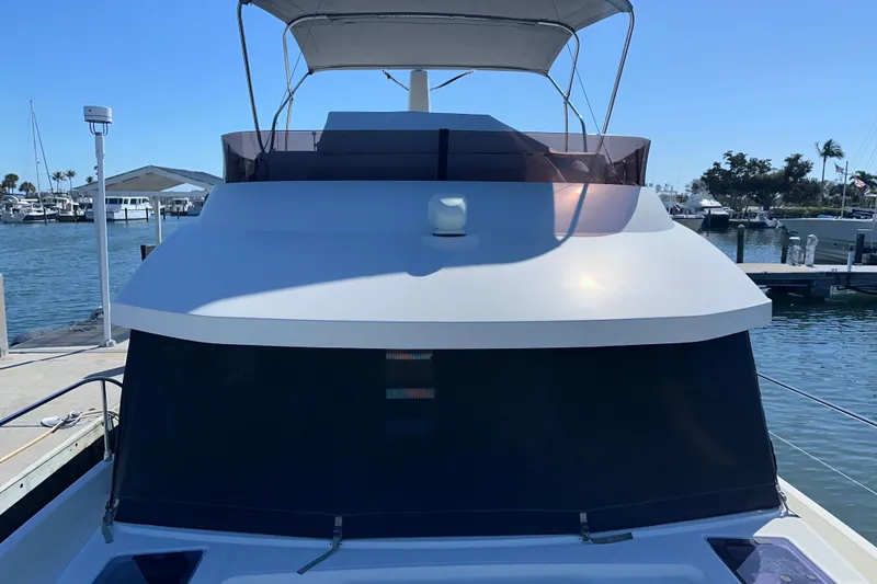 Slide: The Image of 2021 Beneteau Swift Trawler 41 Fly docked at marina, front view. - 23