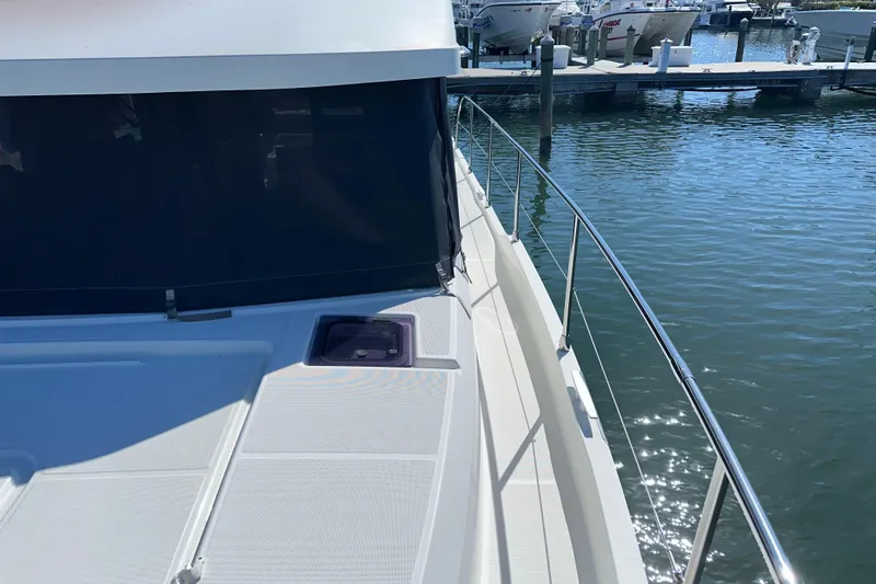 Slide: The Image of 2021 Beneteau Swift Trawler 41 Fly docked, showcasing sleek deck and railing design. - 24