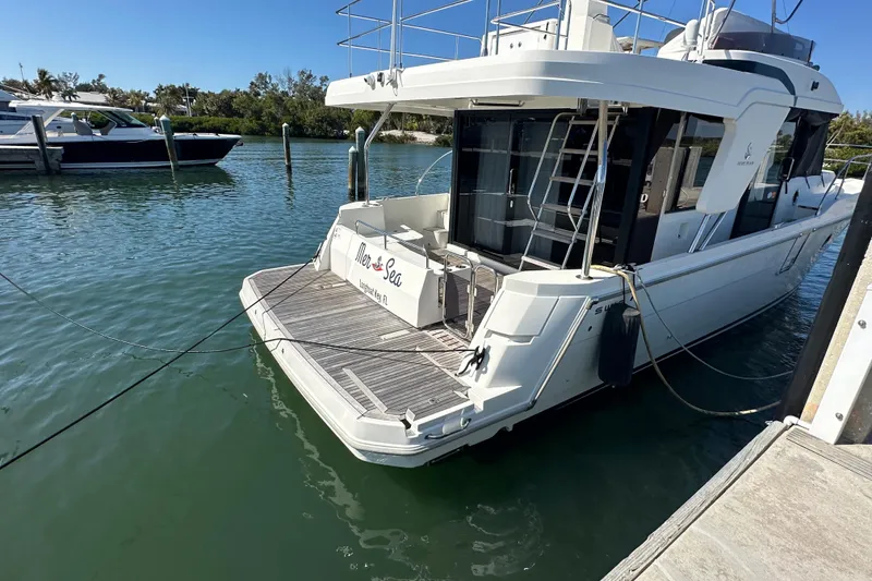 Slide: The Image of 2021 Beneteau Swift Trawler 41 Fly docked in a serene marina setting. - 28