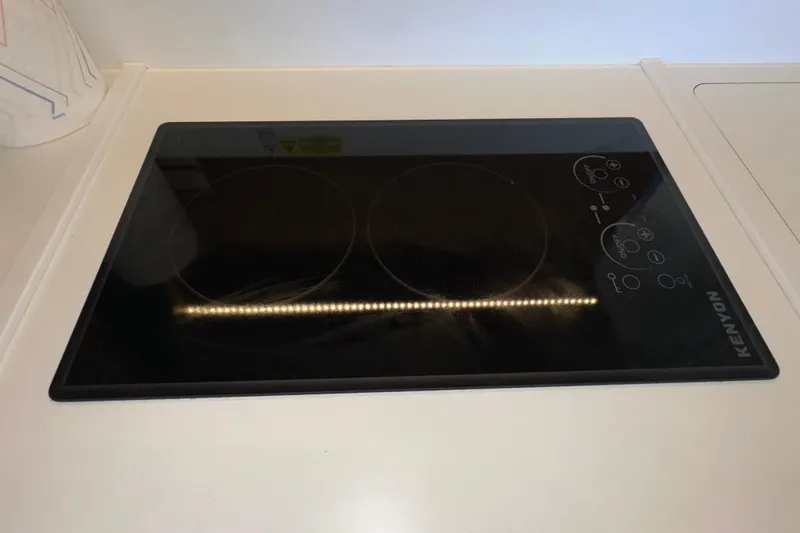 Slide: The Image of Kenyon cooktop on 2021 Beneteau Swift Trawler 41 Fly yacht kitchen counter. - 34