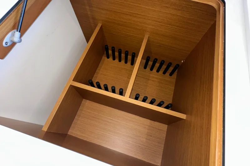 Slide: The Image of Wooden storage compartment with dividers in a 2021 Beneteau Swift Trawler 41 Fly. - 35
