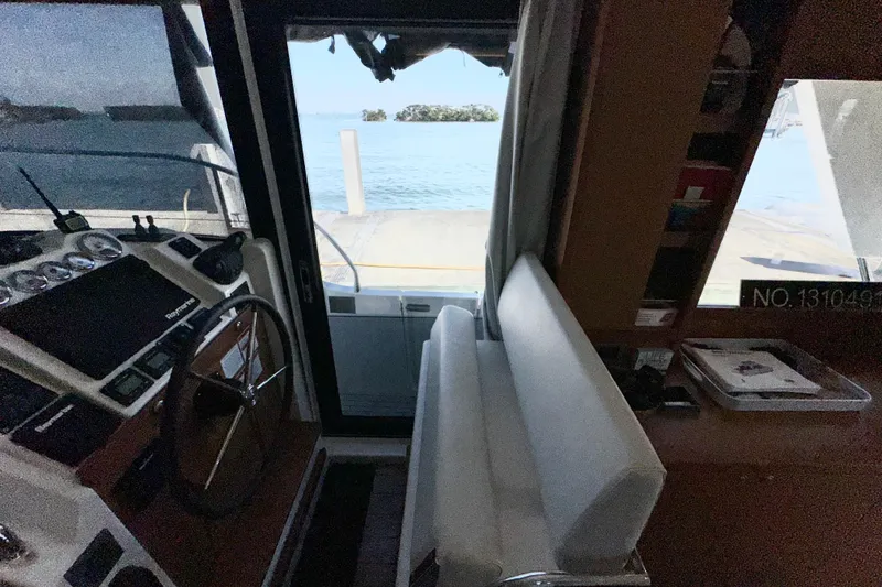 Slide: The Image of Interior view of 2021 Beneteau Swift Trawler 41 Fly, showcasing helm and seating area. - 39