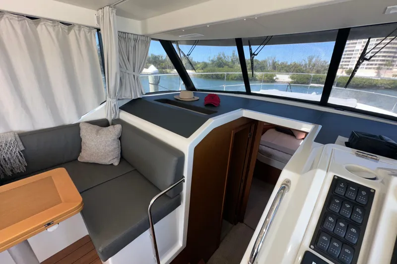 Slide: The Image of Interior of 2021 Beneteau Swift Trawler 41 Fly, featuring seating and helm controls. - 41