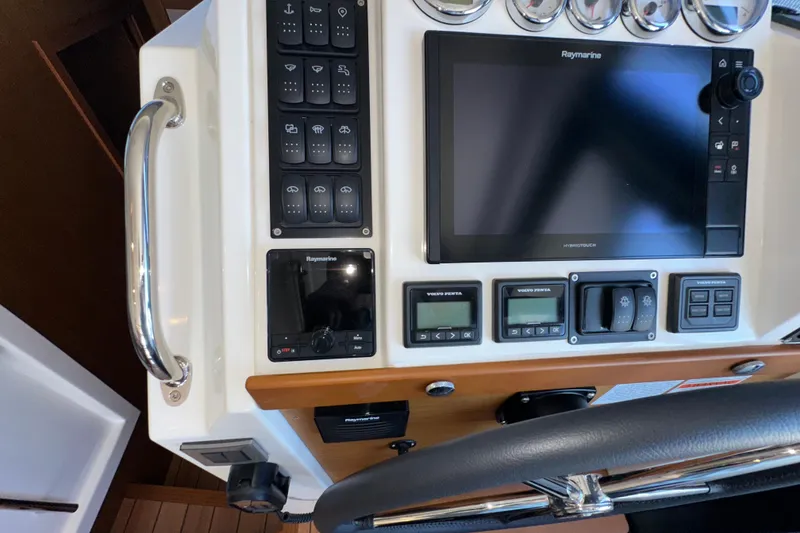 Slide: The Image of Helm controls of 2021 Beneteau Swift Trawler 41 Fly with Raymarine display. - 43