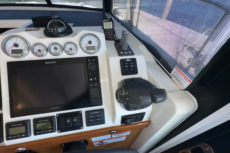 Slide: The Image of 2021 Beneteau Swift Trawler 41 Fly helm with navigation controls and gauges. - 44