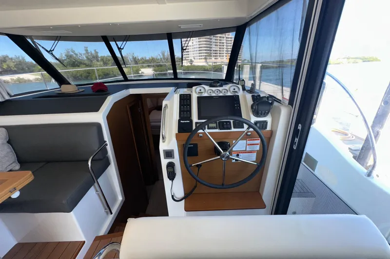 Slide: The Image of Interior helm of 2021 Beneteau Swift Trawler 41 Fly with modern navigation equipment. - 49