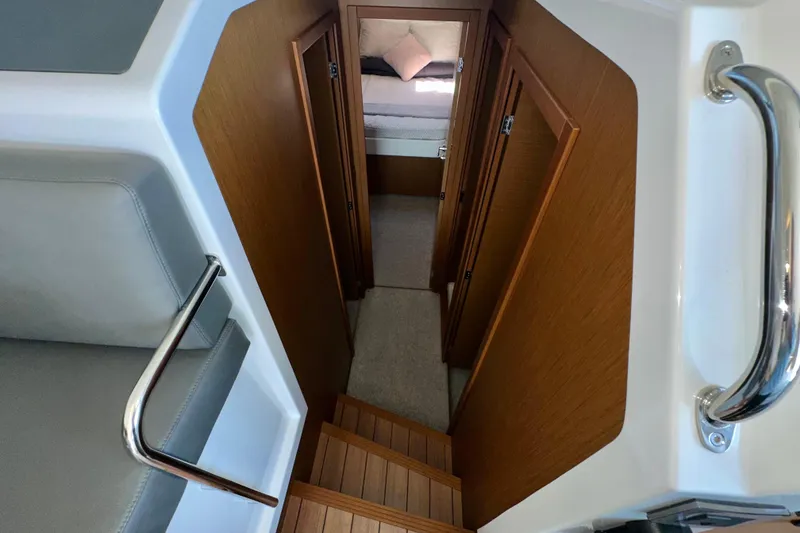 Slide: The Image of Interior view of 2021 Beneteau Swift Trawler 41 Fly, featuring wooden stairs and cozy cabin. - 50