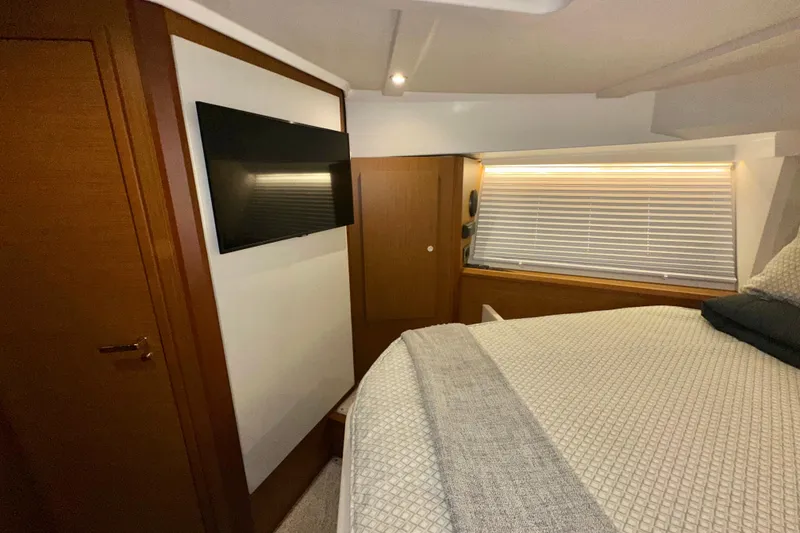 Slide: The Image of Interior of 2021 Beneteau Swift Trawler 41 Fly with TV and cozy bed. - 56