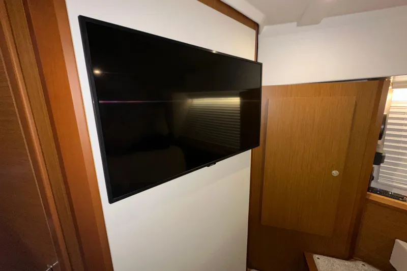 Slide: The Image of Flat-screen TV in 2021 Beneteau Swift Trawler 41 Fly cabin interior. - 60