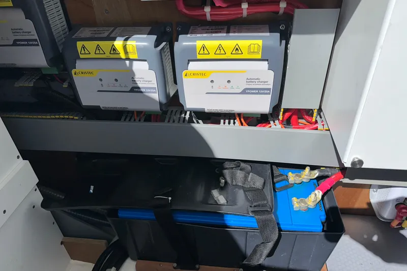 Slide: The Image of Battery chargers and wiring in a 2021 Beneteau Swift Trawler 41 Fly engine room. - 63