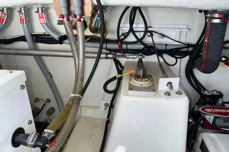Slide: The Image of Engine room of 2021 Beneteau Swift Trawler 41 Fly with visible hoses and wiring. - 67