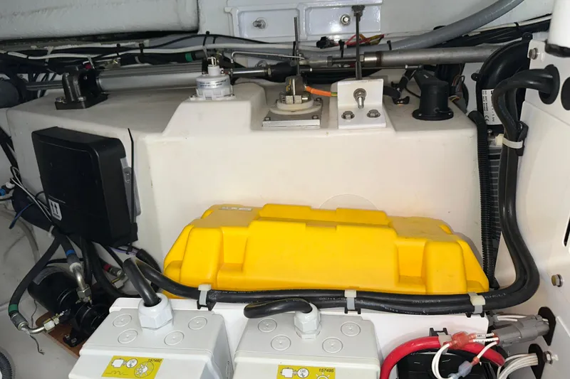 Slide: The Image of Engine compartment of 2021 Beneteau Swift Trawler 41 Fly with battery and wiring. - 68