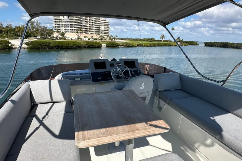 Slide: The Image of 2021 Beneteau Swift Trawler 41 Fly, spacious deck view, coastal scenery. - 7
