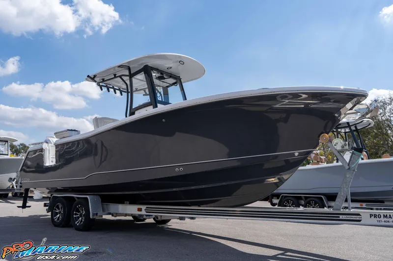 The Image of 2026 Sea Hunt Gamefish 25 boat on trailer under blue sky. - 1