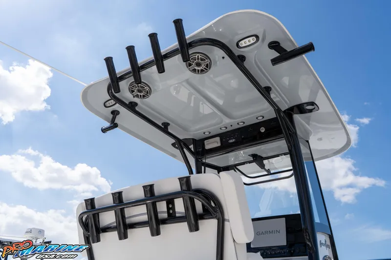 Slide: The Image of 2026 Sea Hunt Gamefish 25 boat with T-top and rod holders under a clear sky. - 14