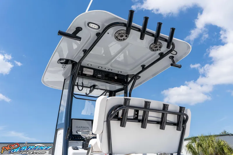 Slide: The Image of 2026 Sea Hunt Gamefish 25 boat with T-top and rod holders under blue sky. - 15