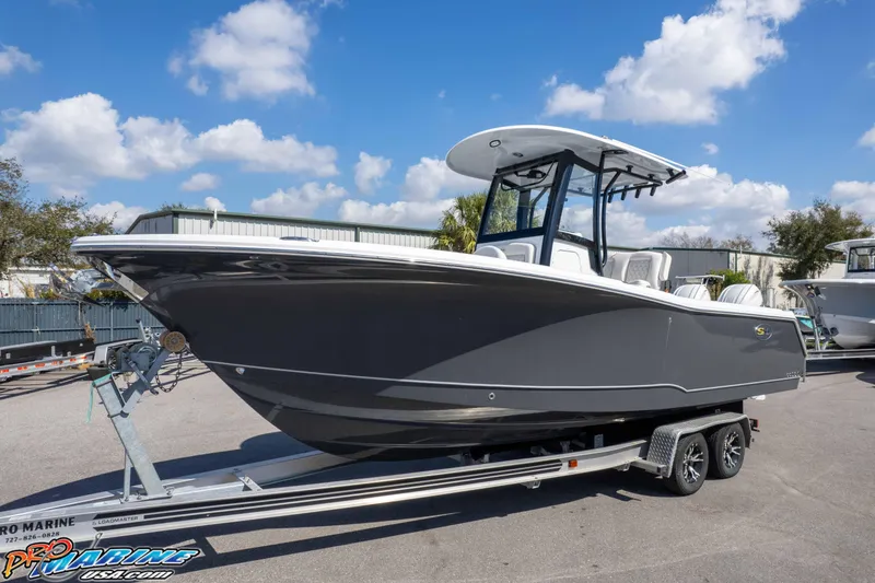 Slide: The Image of 2026 Sea Hunt Gamefish 25 boat on trailer under blue sky. - 31