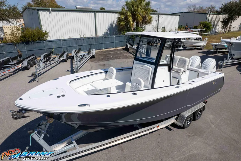 Slide: The Image of 2026 Sea Hunt Gamefish 25 boat on trailer, parked outdoors, ready for adventure. - 32