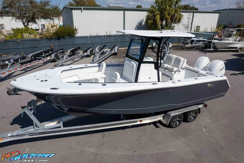 Slide: The Image of 2026 Sea Hunt Gamefish 25 boat on trailer, parked outdoors. - 35
