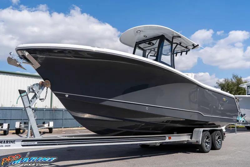 Slide: The Image of 2026 Sea Hunt Gamefish 25 boat on trailer, sleek design, parked outdoors. - 4
