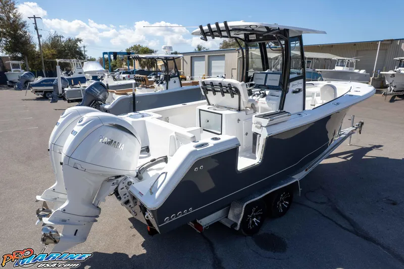 Slide: The Image of 2026 Sea Hunt Gamefish 25 boat with dual Yamaha engines, parked on a trailer. - 43