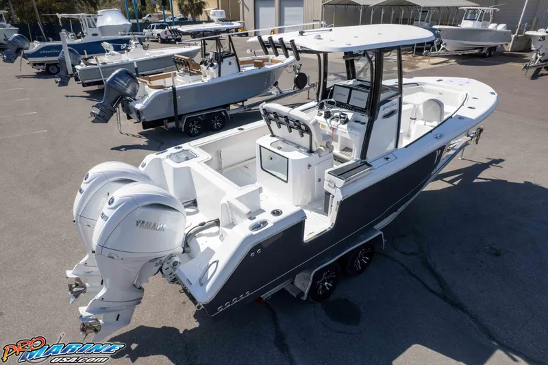 Slide: The Image of 2026 Sea Hunt Gamefish 25 boat with dual Yamaha engines in a marina setting. - 44