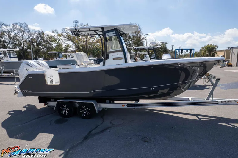 Slide: The Image of 2026 Sea Hunt Gamefish 25 boat on trailer in sunny outdoor setting. - 45