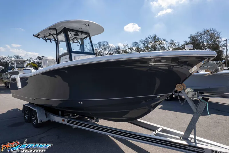 Slide: The Image of 2026 Sea Hunt Gamefish 25 boat on trailer under clear sky. - 47