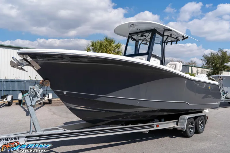 Slide: The Image of 2026 Sea Hunt Gamefish 25 boat on trailer under blue sky. - 5