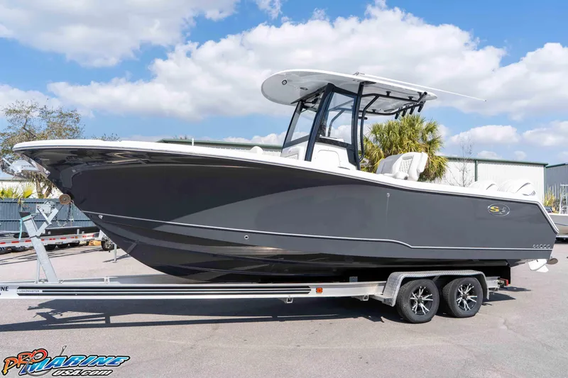 Slide: The Image of 2026 Sea Hunt Gamefish 25 boat on trailer, sleek design, sunny day background. - 6