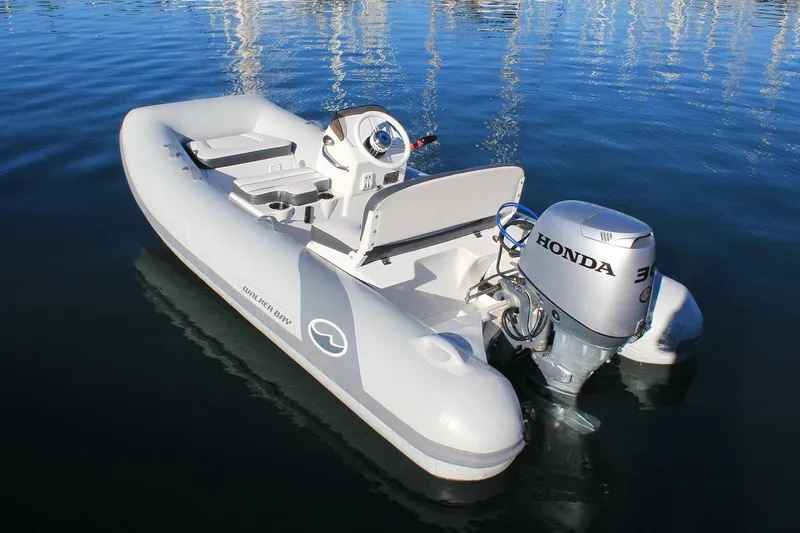Slide: The Image of Manufacturer Provided Image: 2025 Walker Bay 325 STX Deluxe boat with Honda outboard motor on calm water. - 11
