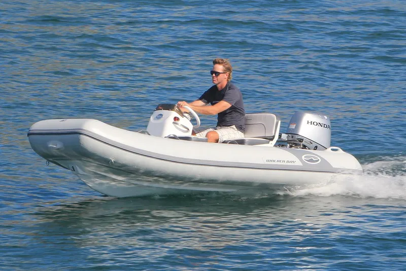 Slide: The Image of Manufacturer Provided Image: 2025 Walker Bay 325 STX Deluxe boat cruising on water with Honda engine. - 7