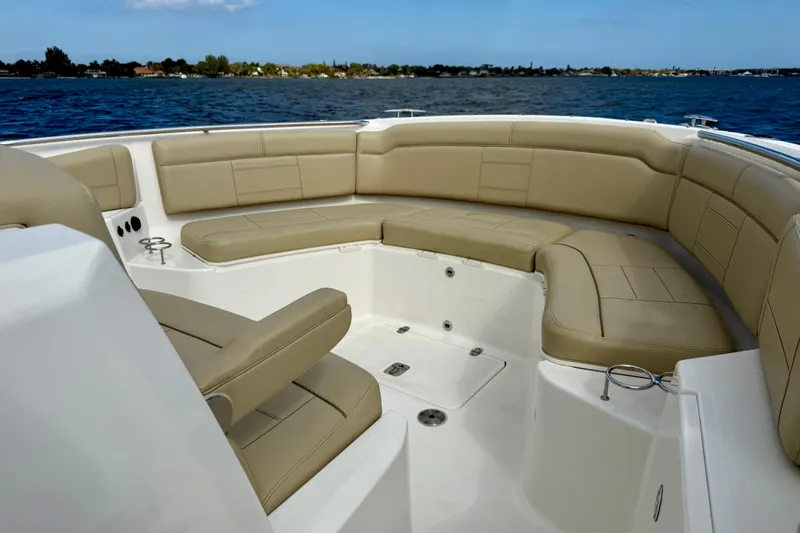 Slide: The Image of 2019 Pursuit S 328 Sport boat with spacious tan seating and ocean view. - 8