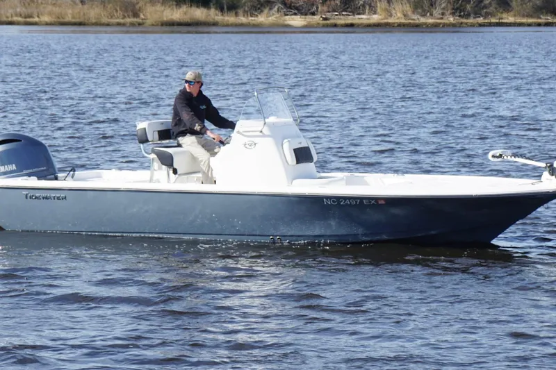 Slide: The Image of 2022 Tidewater 2110 Bay Max boat cruising on a calm river. - 3